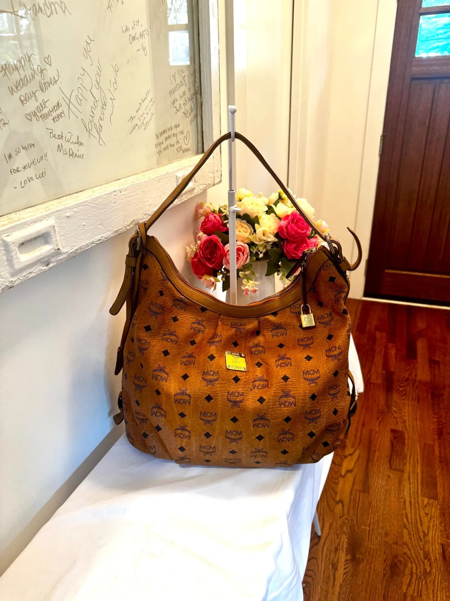 Authenticated Cognac MCM Hobo Bag with lock and key — pre-owned luxury designer bag | LaceLuxx