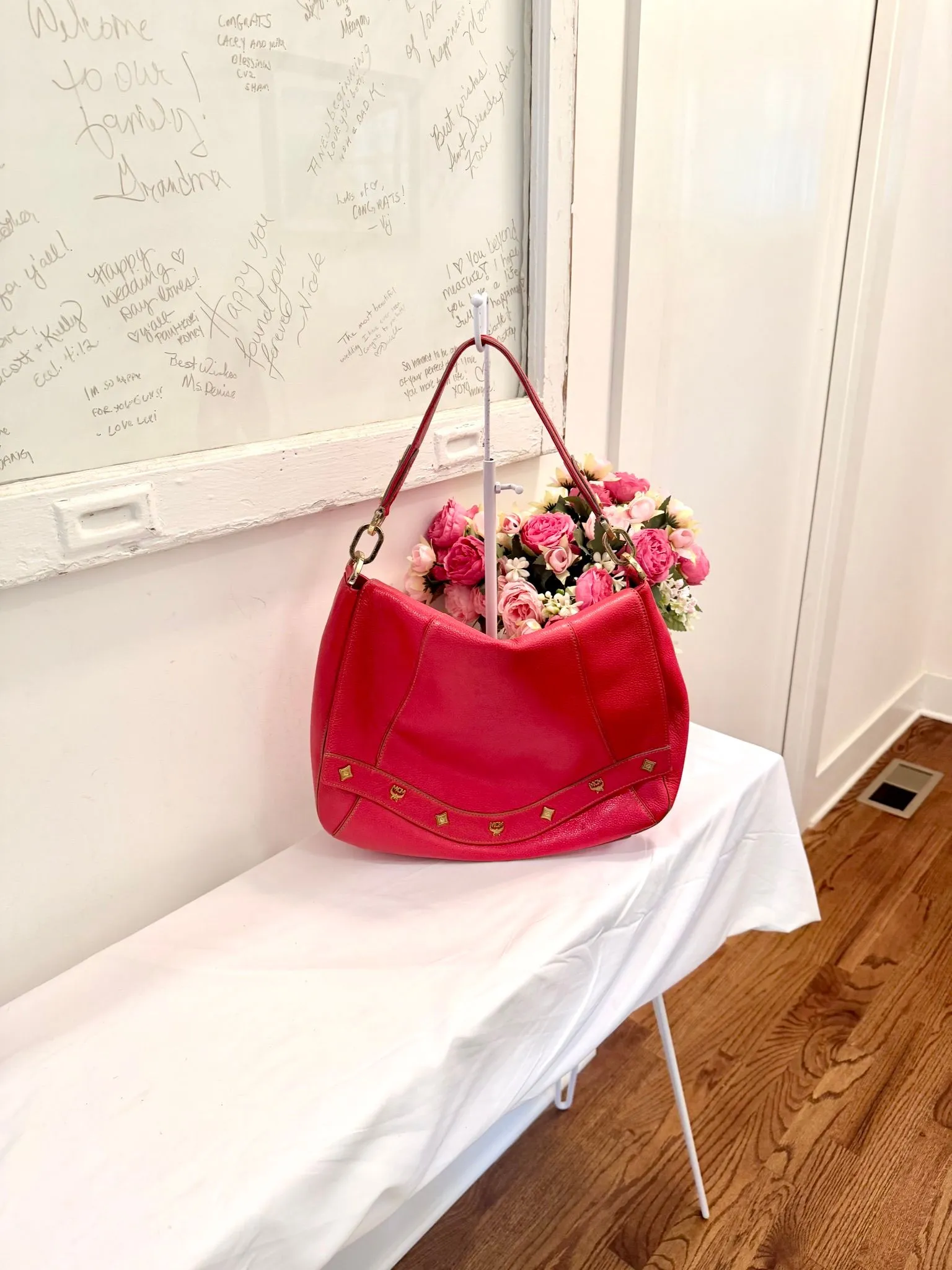 Authenticated Red MCM Saddle Bag with Guitar Strap — pre-owned luxury designer bag | LaceLuxx